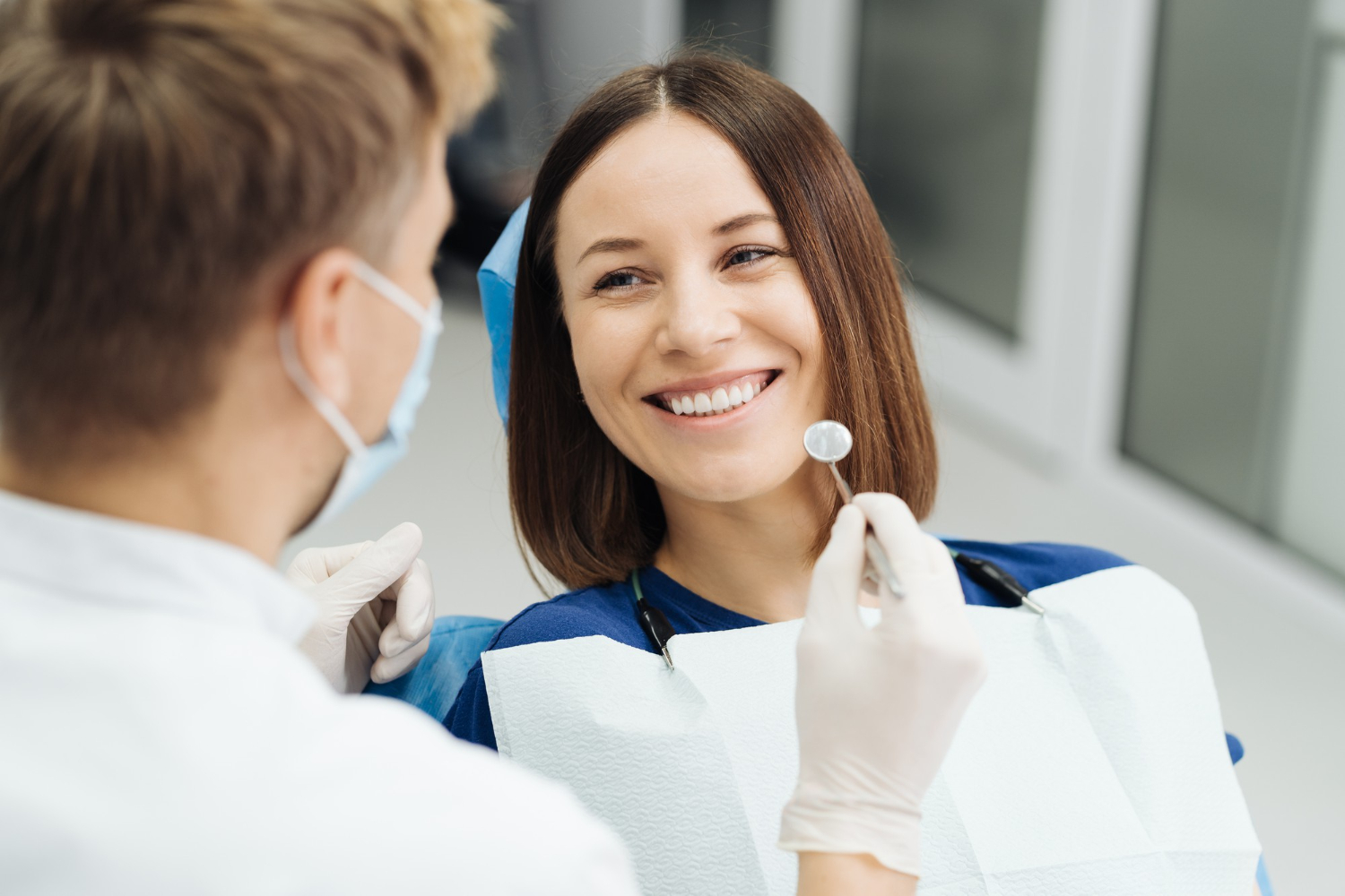 male-professional-dentist-with-gloves-mask-discuss-what-treatment-will-look-like-patient-s-teeth